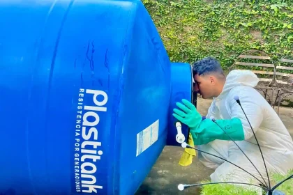 Técnico realizando revisión y mantenimiento de tanque de agua con inspección de conexiones